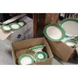 A comprehensive Early 20th century Crown Ducal dinner service with gilded green and cream banding