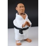 A nodding head figure of Vladimir Putin in Karate costume.