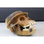 A novelty animal skull probably Primate wearing hat and smoking cheroot.