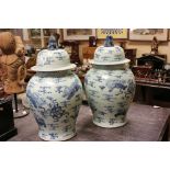 A pair of large Chinese blue and white lidded Temple lidded vases height 68 cm tall .