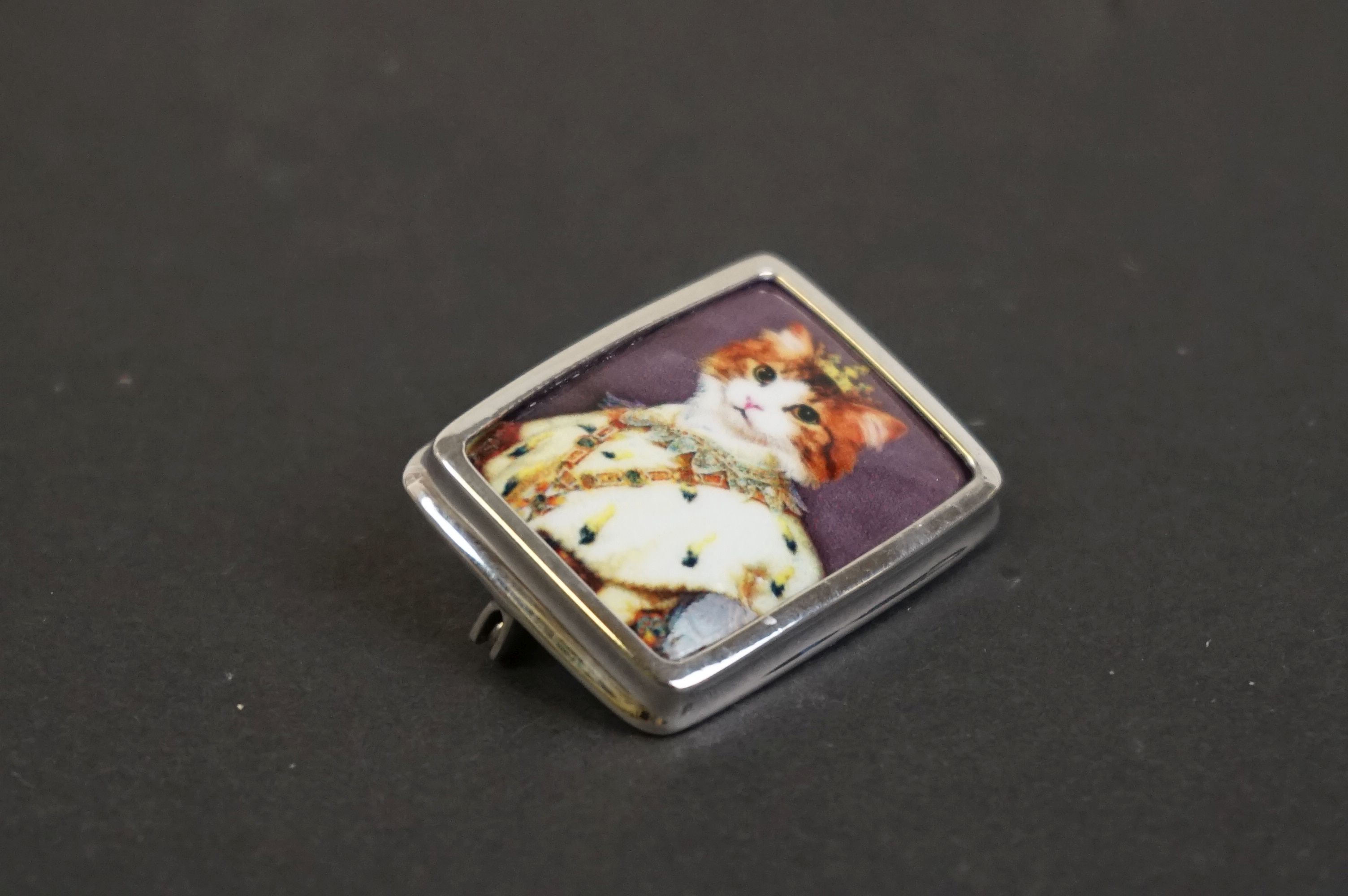 Silver and enamel brooch with pictorial image of a royal cat