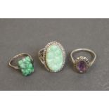 Three silver rings comprising circa 1920s jade ring, a jade and marcasite dress ring, together