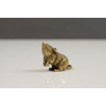 A small brass figure of a mouse or rat.