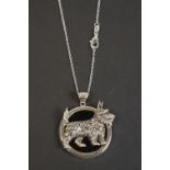 Silver pendant necklace of dog form with ruby eye