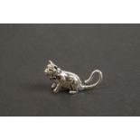 Silver figure of a cat with ruby collar