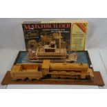 A scratch built wooden model of a steam train together with a scratch built wooden model of a paddle