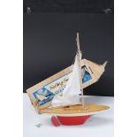 Boxed Uffa Fox Sailing Boat with red/white hull, with sail, and wooden plinth stand, gd box