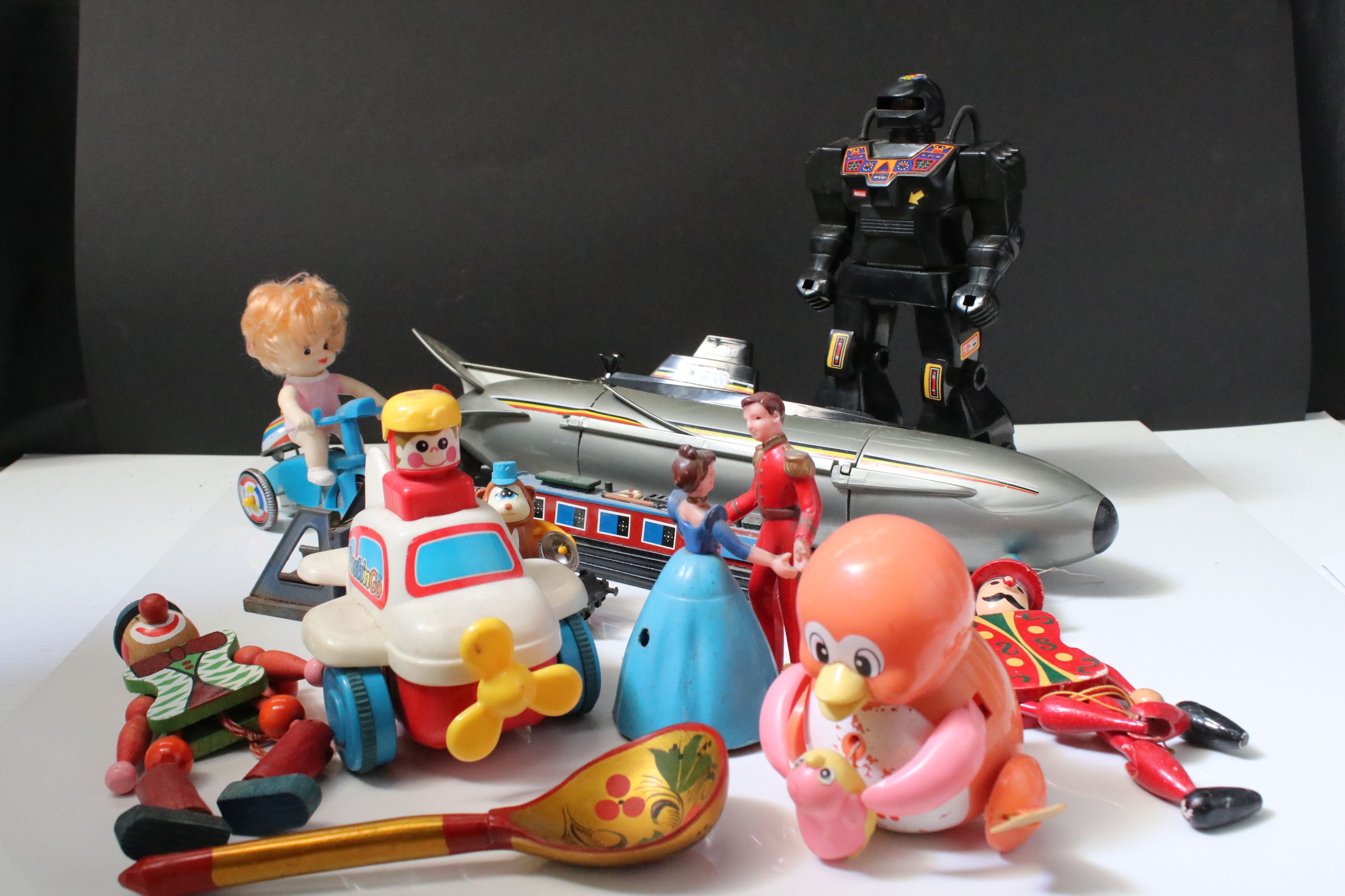Group of mixed toys to include wooden puppets, plastic robot, plastic submarine etc