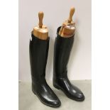 A pair of Aigle riding boots with wooden boot trees.