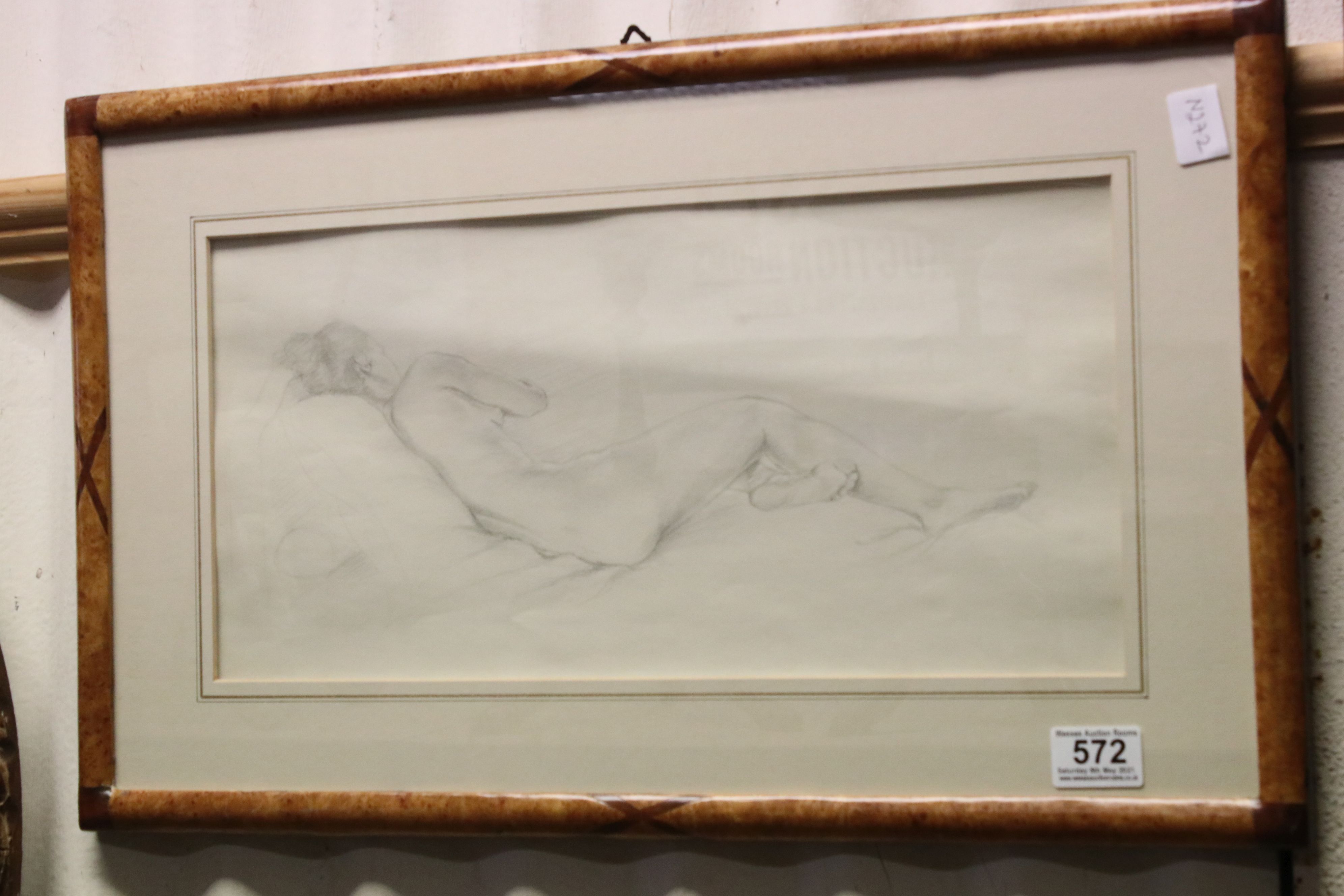 A framed and glazed pencil drawing sketch of a recumbent nude women unsigned 20 x 43 cm.