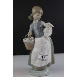 Lladro figure 4835, girl with a lamb in her arms and carrying a basket