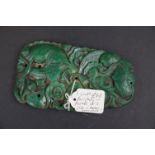 An oriental carved green stone ornament with fish decoration. Measures approx 14.5cm in height.