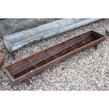 A vintage cast iron free standing water / food trough, measures approx 153cm
