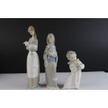 Three Lladro Figures including Girl holding Lilies, Girl holding a Lamb and Angel playing a