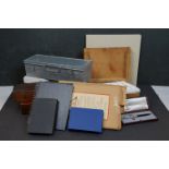 A collection of vintage art supplies and drawing equipment within wooden boxes.
