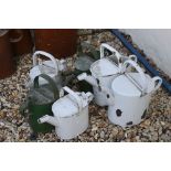 A collection of six vintage painted watering cans