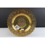 An arts and Crafts early 20th century brass dish with stylized etched decoration to edge dated