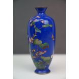 An Oriental blue enamel vase with butterfly and floral decoration.