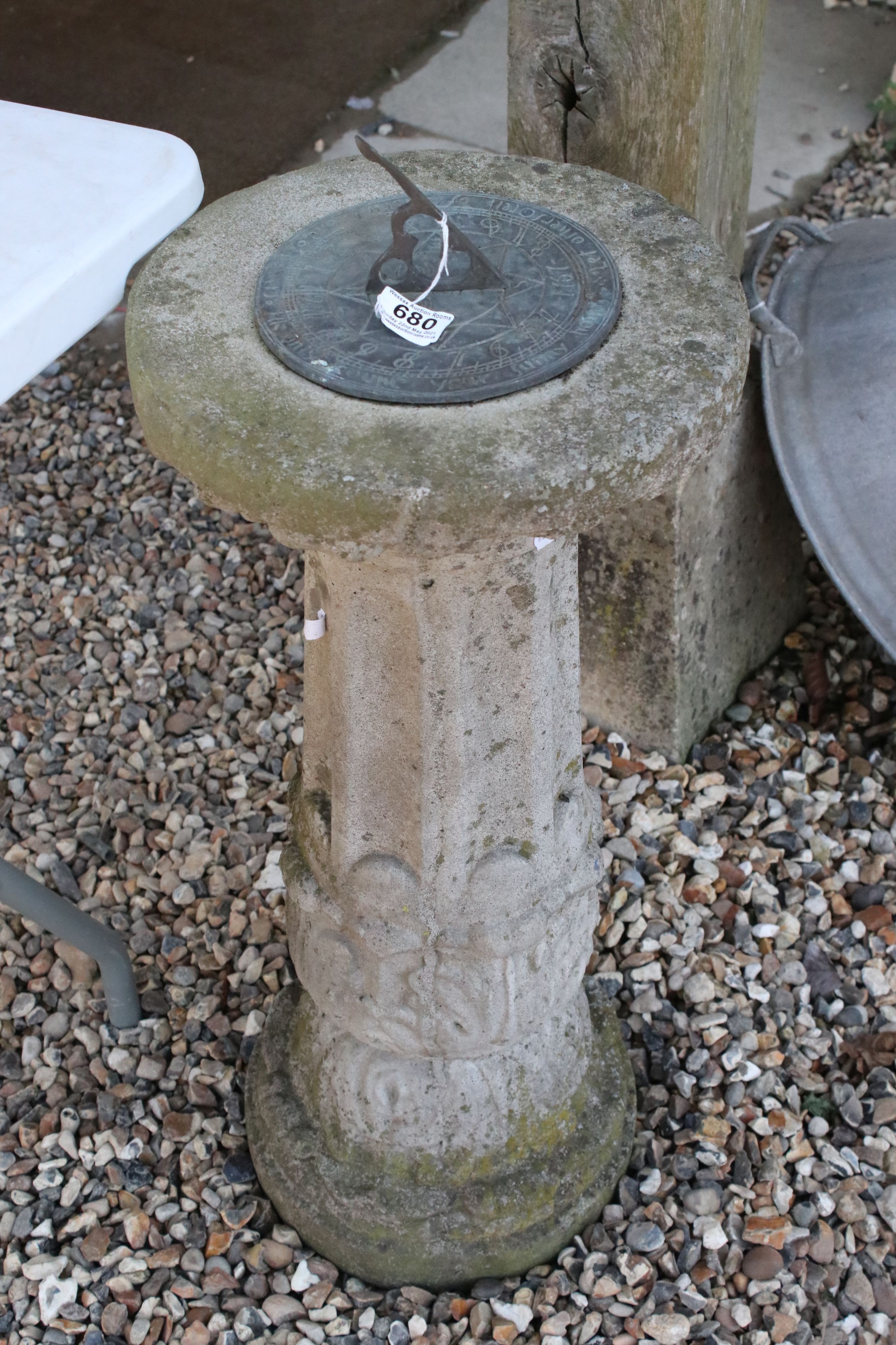 A vintage bronze sundial on stone plinth.