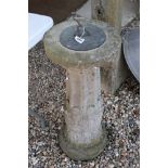 A vintage bronze sundial on stone plinth.