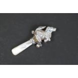 Silver baby's rattle in the form of a dog, with mother-of-pearl handle