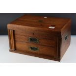 An early 20th century oak two drawer canteen with brass handles.