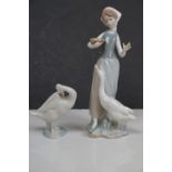 A Lladro figure of a lady and goose together with another goose.