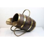 A vintage brass bound wooden barrel coal scuttle.