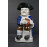 A 19th century antique Enoch Wood style Toby Jug, approx. 25cm tall, restoration to hat