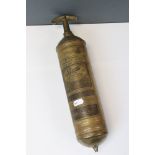 A vintage brass Pyrene hand pump type fire extinguisher.