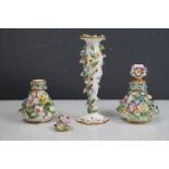 A pair of antique floral decorated Meissen lidded bottles together with a Meissen candlestick of
