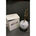 A group of collectables to include a brass companion set, enamel bread bin and a blue & white lamp.