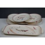 A set of six poole pottery fish plates together with a platter.