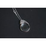 Silver magnifying glass pendant necklace in the form of a horse