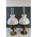 Two vintage Aladdin oil lamps with original glass chimneys, approx 23" in height.