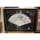 An antiquebox framed Chinese ivory and feather fan decorated with flowers and figures two students