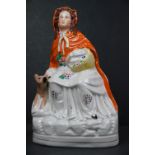 An antique Staffordshire figure of Red Riding Hood and the Wolf.