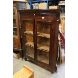 19th century Oak Corner Cabinet with two glazed doors opening to two pine shelves, raised on ball