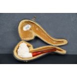 A hand carved block meerschaum pipe with middle eastern headed bowl, complete with fitted case.