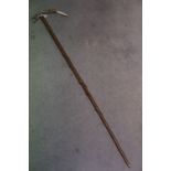 A rustic wooden walking stick possibly Holly with white mounted antler handle..