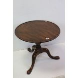 George III Mahogany Pedestal Lamp Table with circular tray top and raised on three splay legs, 66cms