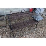 A vintage garden bench seat with wrought iron ends.