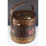 An early 20th century lidded container with a handle, decorated with pokerwork and painted fruit.