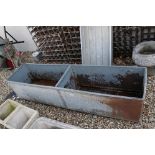 A large petitioned galvanised water trough, measures approx 184 x 47cm