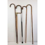 A collection of five vintage walking sticks.