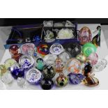 A collection of over thirty glass paperweights to include Caithness examples.