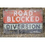 A metal 'Road Blocked' diversion sign, measures approx 91 x 56cm.