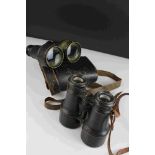 A pair of world war one era British military issued field binoculars, marked with the broad arrow