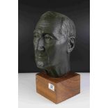 A 20th century hollow bronzed bust of a man mounted on a wooden plinth unsigned.