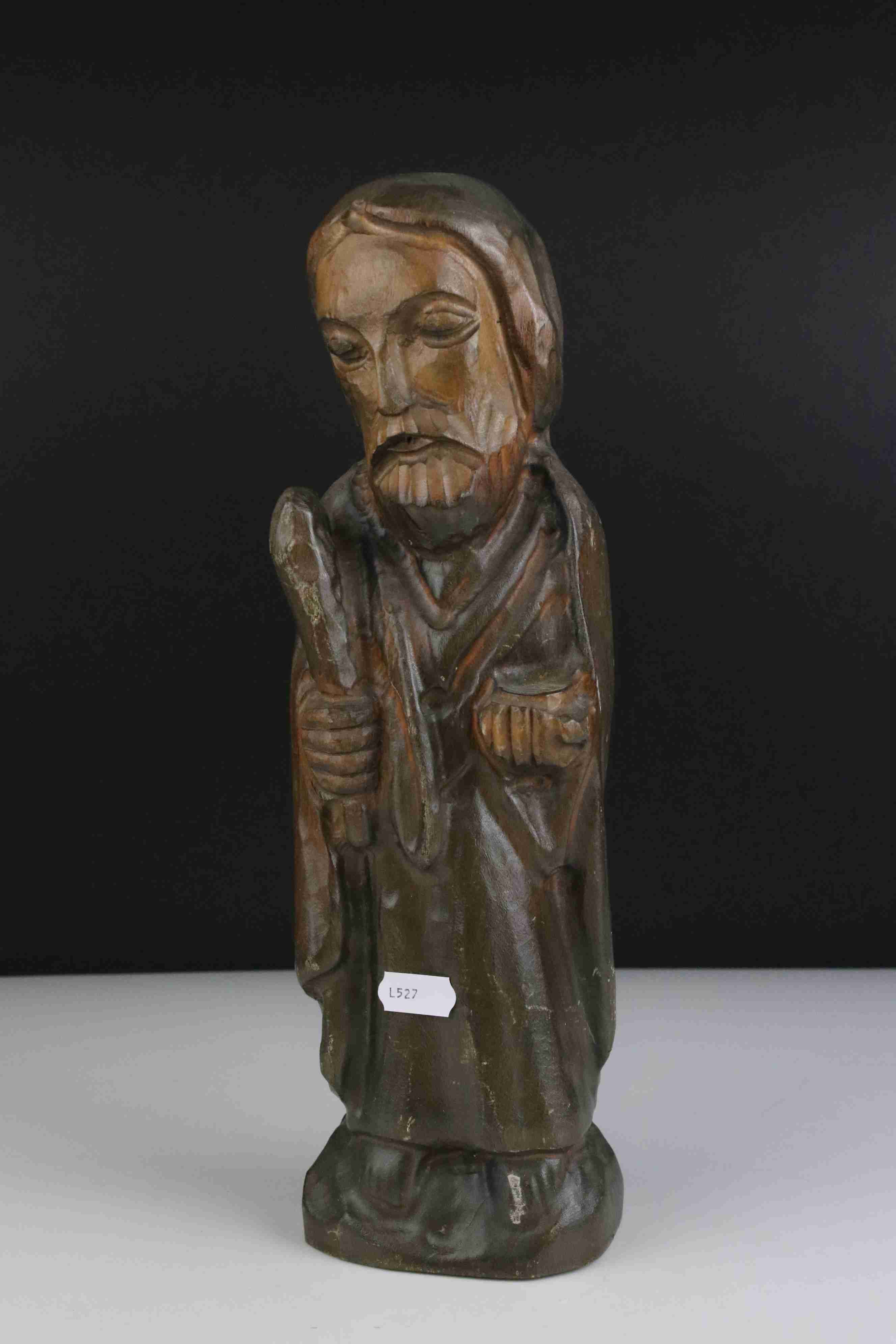 A carved wooden figure of a religious figure.